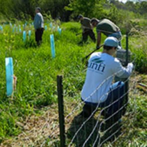 Image: UNFI associate working on fence.